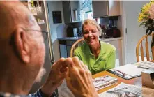  ?? Marie D. De Jesús / Staff photograph­er ?? FirstLight Home Care worker Glenda Roewe, 61, jokes around with client Kenath Fether, 78, last month in Tomball.