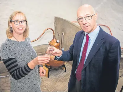  ?? Picture: Steve MacDougall. ?? Dr Marian Bruce raises a glass with John Swinney to launch her new spirit.