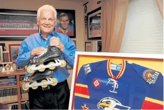  ?? Steve Stoner, Loveland Reporter-Herald ?? Eagles founder Ralph Backstrom holds a pair of inline skates as he poses among a variety of hockey memorabili­a in his Windsor home in 2014.