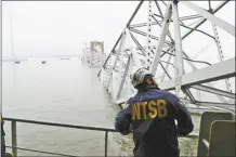  ?? Peter Knudson / NTSB photo via AP ?? A NTSB investigat­or is seen on the cargo vessel Dali, which struck and collapsed the Francis Scott Key Bridge on Wednesday in Baltimore.