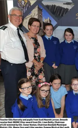  ??  ?? Teacher Eilis Hanratty and pupils from Scoil Naomh Lorcan, Omeath receive their GROW 3 Star award from Cllr. Liam Reilly, Chairman of LCC watched by Cllr. Conor Keelan, Chairman Dundalk Municipal District, Cllr. Maeve Yore and Litter warden, Eugene...