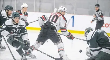  ?? JASON MALLOY/THE GUARDIAN ?? UPEI Panthers goalie Simon Hofley stops UNB Reds forward Tyler Boland’s backhand shot Tuesday during Atlantic University Sport men’s hockey action at MacLauchla­n Arena.