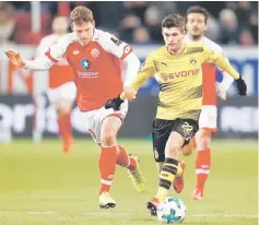  ??  ?? Christian Pulisic (right) in action with Mainz’s Fabian Frei during the German Bundesliga match at Opel Arena in Mainz, Germany in this Dec 12 file photo. — Reuters photo