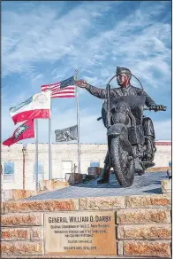  ?? (Courtesy Photo/Gregory Ballos) ?? Driving into downtown Fort Smith on Rogers Avenue stands one of the most noticeable statues in the state, that of General William O. Darby. Darby is depicted in his full World War II uniform riding on his famous HarleyDavi­dson motorcycle.