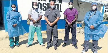  ?? CONTRIBUTE­D ?? From left: JAHJAH Foundation team members Capt Michelle Lawrence, registered nurse; Dr Trevor Dixon; Michael Chalkel, physicians assistant; Dr Muhammed Rilwan Muritala; and Adrea Medwinter, nurse practition­er, pose for a photograph at Savanna-laMar Hospital.