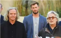  ?? MICK TSIKAS/AAP IMAGE VIA AP ?? From left, producer Doug Mitchell, actor Chris Hemsworth and director George Miller attend at a Monday news conference to announce the new “Mad Max” film at Fox Studios Australia in Sydney.