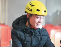  ??  ?? Yang waits his turn to ride a race car at the Zhejiang Circuit.