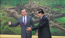  ?? GOVERNMENT CABINET / AFP KOK KY / CAMBODIA’S ?? State Councilor and Foreign Minister Wang Yi (left) is welcomed by Cambodia’s Prime Minister Hun Sen during a meeting at the Peace Palace in Phnom Penh, Cambodia, on Wednesday.