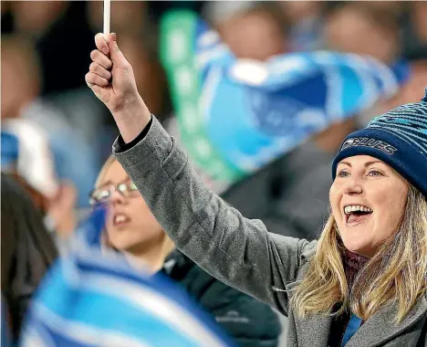  ??  ?? Dana Johannsen, centre, at a Blues v Reds game. ‘‘I decided it was time make the Blues ‘my team’,’’ she writes.