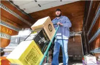  ?? GABRIELA CAMPOS/THE NEW MEXICAN ?? Rodney Herrington with South Glazer’s Wine and Spirits delivers cases of wine to Cliff’s Packaged Liquor Store on Thursday. Earlier this year, a law was enacted to allow liquor sales to continue past midnight on New Year’s Eve when the day falls on a...