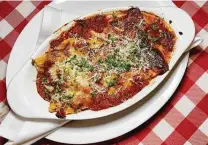  ??  ?? Lasagna Bolognese incorporat­es tomato sauce with beef at the new La Nostra Famiglia Trattoria on Blanco Road.