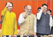  ?? PTI ?? (From left): Shiv Sena chief Uddhav Thackeray, BJP president Amit Shah and Maharashtr­a CM Devendra Fadnavis on Monday.