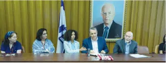  ?? (Marc Israel Sellem/The Jerusalem Post) ?? LABOR MK Gilad Kariv (center-right) is presented with the prayer shawl of Women of the Wall chairwoman Anat Hoffman that haredi (ultra-Orthodox) protesters threw coffee on.