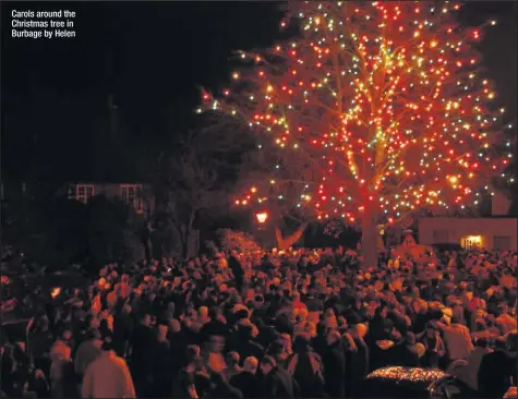  ??  ?? Carols around the Christmas tree in Burbage by Helen