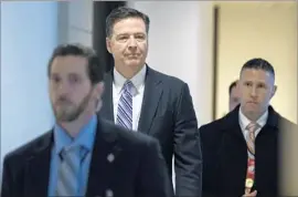  ?? Jim Lo Scalzo European Pressphoto Agency ?? L AW M A K E R S may push FBI Director James B. Comey, center, to say publicly whether the FBI surveilled President Trump before or after last year’s election.