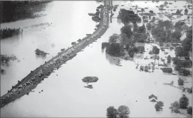  ?? Democrat-Gazette file photo courtesy of Robert Moore ?? Tents line the levee at Arkansas City during the 1927 flood. The Mississipp­i River is at left of the levee; to the right is floodwater from the Arkansas River. The flood devastated Arkansas’ agricultur­al economy and was especially hard on sharecropp­ers.