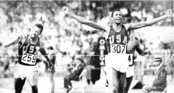  ?? SUN-TIMES PRINT COLLECTION ?? Tommie Smith throws his arms up in victory as he hits the tape to win a gold medal in the men’s 200 meters at the 1968 Olympics in Mexico City.