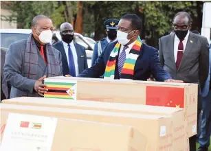  ??  ?? President Mnangagwa receives personal protective equipment( PPEs) sourced by Vice President Constantin­o Chiwenga while Vice President Kembo Mohadi looks on at State House in Harare yesterday