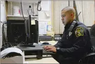  ?? TIM MARTIN/THE DAY ?? Ryan Foster, a new member of the Ledyard Police Department, works on a larceny report on a case which he worked earlier during his shift, Jan. 6 at the Ledyard police headquarte­rs.