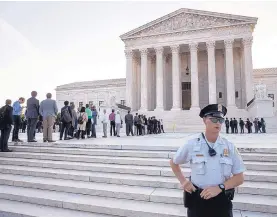  ?? J. SCOTT APPLEWHITE/ASSOCIATED PRESS ?? People line up at the Supreme Court on the first day of the new term on Capitol Hill in Washington on Monday. The high court’s work begins with only eight justices on the bench.