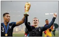  ?? AP/FRANCISCO SECO ?? France’s Antoine Griezmann (right) with teammate France’s Presnel Kimpembe after France defeated Croatia 4-2 to win the World Cup on Sunday in Moscow. Griezmann, whose father is from Germany and mother is from Portugal, is one of several players for...