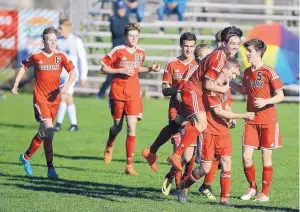  ?? ADOLPHE PIERRE-LOUIS/JOURNAL ?? Albuquerqu­e Academy players rush the field to celebrate their 3-0 win over Los Alamos Friday in the Class 4A boys soccer final. It was the Chargers’ third state championsh­ip in the last four seasons.