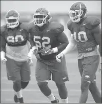  ?? NWA Democrat-Gazette/Andy Shupe ?? DEFENSIVE FRONT: Arkansas defensive linemen Armon Watts (90), T.J. Smith (52) and Randy Ramsey participat­e in a drill Tuesday during the Razorbacks’ practice in Fayettevil­le.