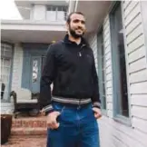  ?? —AP ?? ALBERTA: Omar Khadr walks out the front door of his lawyer Dennis Edney’s home to speak to the media in Edmonton, Alberta.