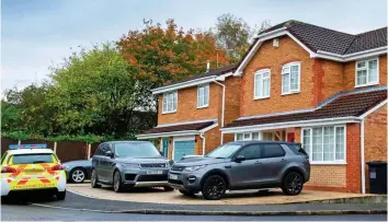  ??  ?? Early morning raid: Police at the Mahers’ £ 400,000 Warrington home yesterday