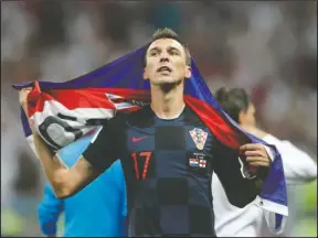  ?? The Associated Press ?? CROAT HERO: Croatia’s Mario Mandzukic celebrates after his team advanced to the final after defeating England at the 2018 FIFA World Cup in Moscow, Russia, Wednesday. Croatia will face France in the World Cup final Sunday at 10 a.m.