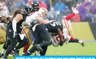  ??  ?? BALTIMORE: Jaylon Ferguson #45 of the Baltimore Ravens tackles Raheem Mostert #31 of the San Francisco 49ers at M&T Bank Stadium in Baltimore, Maryland. —AFP