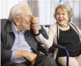  ?? AP FILE ?? Kirk Douglas kisses wife Anne’s hand during a party celebratin­g his 100th birthday in 2017.