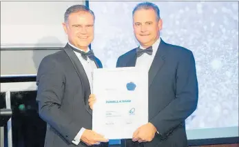  ?? PICTURE / SUPPLIED ?? Top Energy chief executive Russell Shaw (right) receiving his fellowship from Engineerin­g New Zealand president Dean Kimpton.