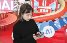  ?? — AFP photos ?? Lu Yu, head of Product Management and Operations of Wantalk, an artificial intelligen­ce chatbot created by Chinese tech company Baidu, scrolling through virtual character profiles on her phone, at the Baidu headquarte­rs in Beijing.