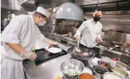  ?? Photo: Jonathan Wong ?? Jayson Tang (right), executive Chinese chef at Man Ho restaurant, in its kitchen in the JW Marriott Hotel in Admiralty.