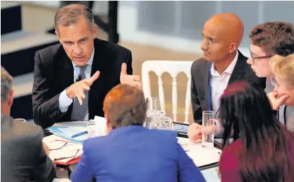  ??  ?? > Bank of England Governor Mark Carney speaks with members of the public at the Future Forum in Birmingham