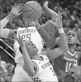  ?? AP/JAMES CRISP ?? Arkansas’ Daniel Gafford (right) reaches in to try to take control of the ball from Kentucky’s Keldon Johnson (3) and PJ Washington during the Razorbacks’ 70-66 loss to the No. 4 Wildcats on Tuesday at Rupp Arena in Lexington, Ky.