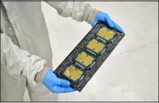  ?? PHILIP CHEUNG — NEW YORK TIMES FILE ?? A worker holds a tray of chips at Intel’s factory in Chandler, Ariz. Under new rules, U.S. companies can no longer supply advanced computing chips, chip-making equipment and other products to China without a special license.