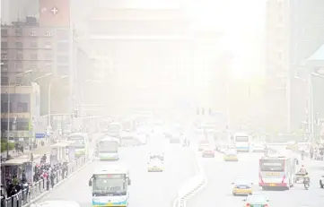  ??  ?? File photo shows vehicles on a road during unusually high levels of dust in Beijing. — AFP photo