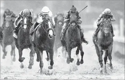  ?? DARRON CUMMINGS/AP ?? Mike Smith rides Justify to victory during the 144th running of the Kentucky Derby on May 5 in Louisville, Ky.