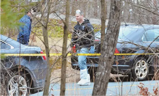  ?? STAFF PHOTOS BY CHRIS CHRISTO ?? ‘LOT OF MOVING PARTS’: Worcester District Attorney Joseph D. Early Jr., top, gives a press conference yesterday outside the West Brookfield home where a mother and three children were found murdered Thursday. Above, investigat­ors work at the scene.