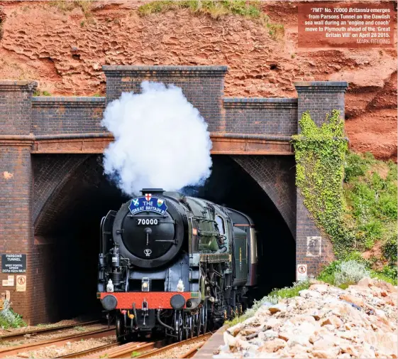  ?? MARK FIELDING ?? ‘7MT’ No. 70000 Britannia emerges from Parsons Tunnel on the Dawlish sea wall during an ‘engine and coach’ move to Plymouth ahead of the ‘Great Britain VIII’ on April 28 2015.