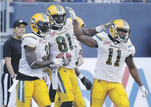  ?? JOHN WOODS/THE CANADIAN PRESS ?? Edmonton Eskimos rookie receiver D’haquille Williams (No. 81) celebrates a touchdown with teammates Natey Adjeiw and K.J. Maye during exhibition action against Winnipeg. The Eskimos are gambling that Williams has put his checkered past behind him.