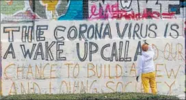  ??  ?? Art student Gregory Borlein prepares a graffiti on a wall in Munich, Germany.
AP