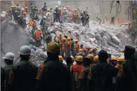  ?? SASHENKA GUTIERREZ/EFE ?? Rescue services members work under the debris of a building on Wednesday that collapsed after a 7.1 magnitude earthquake in Mexico City, Mexico.