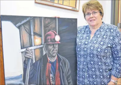  ?? SHARON MONTGOMERY-DUPE/CAPE BRETON POST ?? Artist Kim Brown MacDonald of Glace Bay shows an oil painting of coal miner Sandy White, which will be one of 24 pieces of her work featured in a solo show at the Main Street Art Gallery in the New Waterford Credit Union. The show opens Friday from 3-5 p.m.