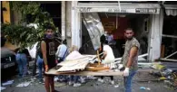  ??  ?? Volunteers and members of the civil society clean the rubble in a street of the damaged trendy Beirut neighborho­od of Mar Mikhael.