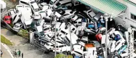  ?? —REUTERS ?? AFTER ‘JEBI’ Vehicles left in a pile in Kobe after floods swept them away at the height of Typhoon “Jebi.”