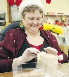  ??  ?? Colleen Renaud was busy organizing tickets and vouchers for the Windsor Goodfellow­s food drive in December 2008.