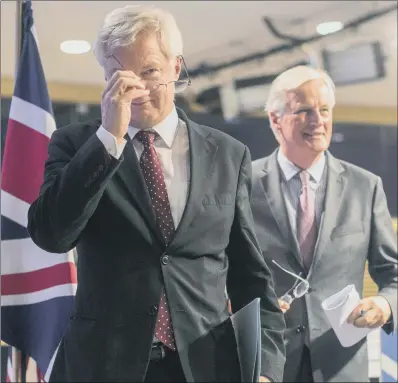  ??  ?? Chief EU negotiator Michel Barnier, right, and Brexit Secretary David Davis leave a press conference in Brussels.